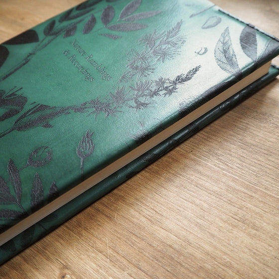 Close-up of the Garden Journal Cover showing the leaf and other nature-inspired engravings. 