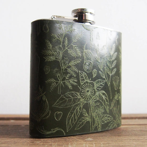 Closer look at the the engraving of the floral hip flask.