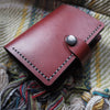 The Compact Mountain Purse, a personalised leather purse with a popper put on.