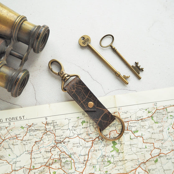 A personalised leather key fob featuring a custom road map.