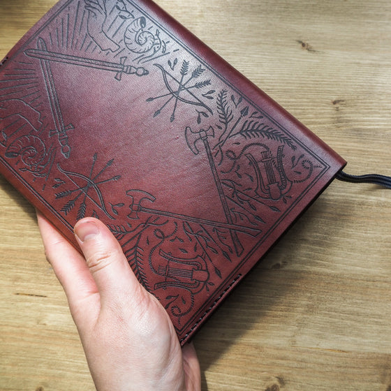 A person holding the Dungeoneers Notebook Cover.