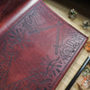 The Dungeoneers Notebook Cover engraved with symbols pertaining to your adventure!