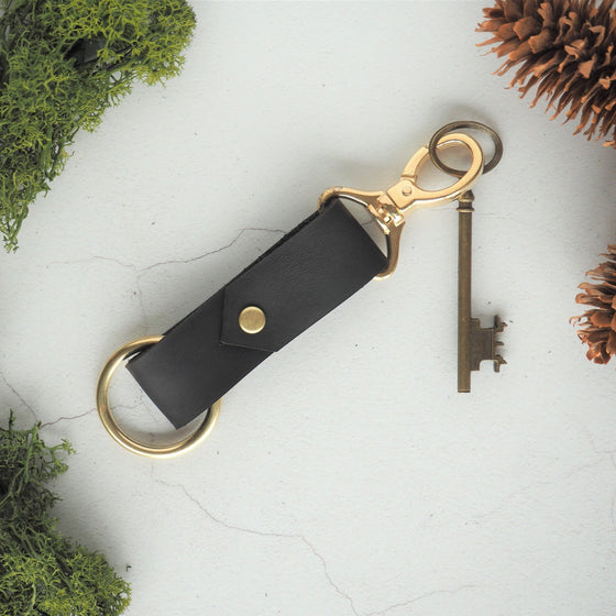 The Halda Leather Key Fob on black leather, brass hardware material, and no personalisation. 