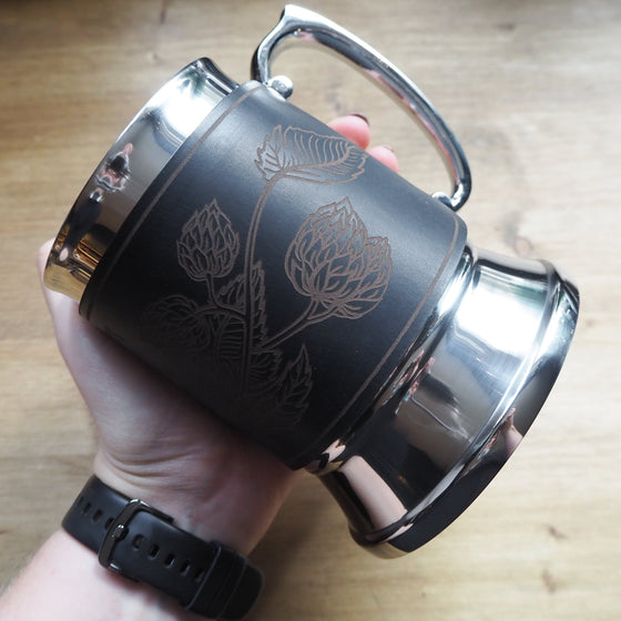 A person holding on the Hop Vine Tankard.