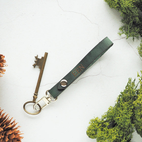 The Lykill Leather Key Ring on green leather colour and custom initials engraved. 