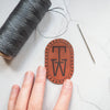 This monogrammed patch is engraved with a custom initial.