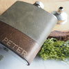 A custom hip flask featuring the Moss Leather Flask.
