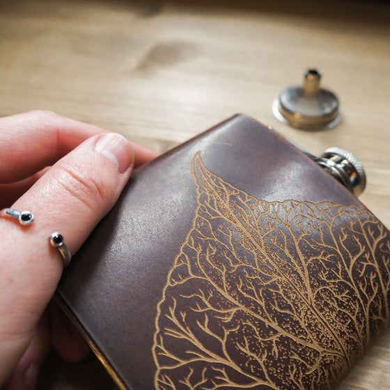 This custom engraved flask is engraved with a mulberry leaf.