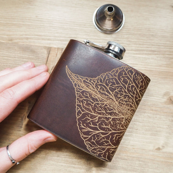This custom engraved flask is handcrafted from luxurious leather that clad onto a stainless steel hip flask.