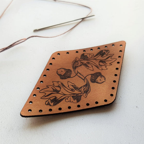 The texture of the flowing engraving on this acorn and oak leaf leather patch is beautiful to behold. The oak leaf patch from Hord.