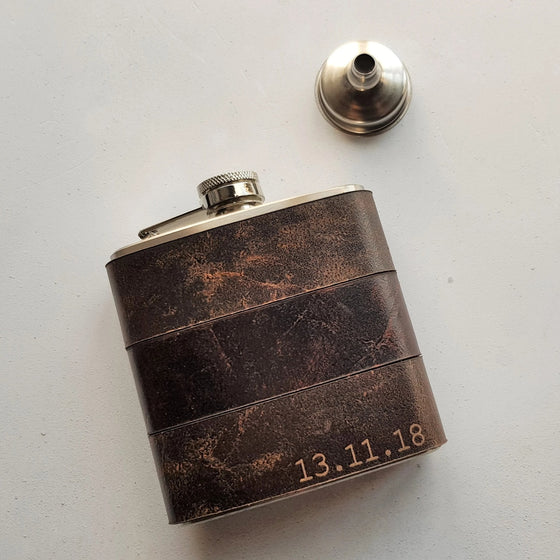 This engraved leather hip flask is personalised with a date on the bottom right corner.