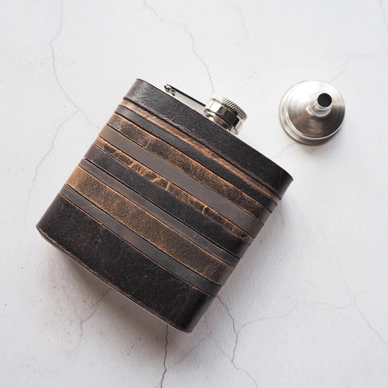 This vintage hip flask has been handcrafted with leather remnants to craft a peat layered flask.
