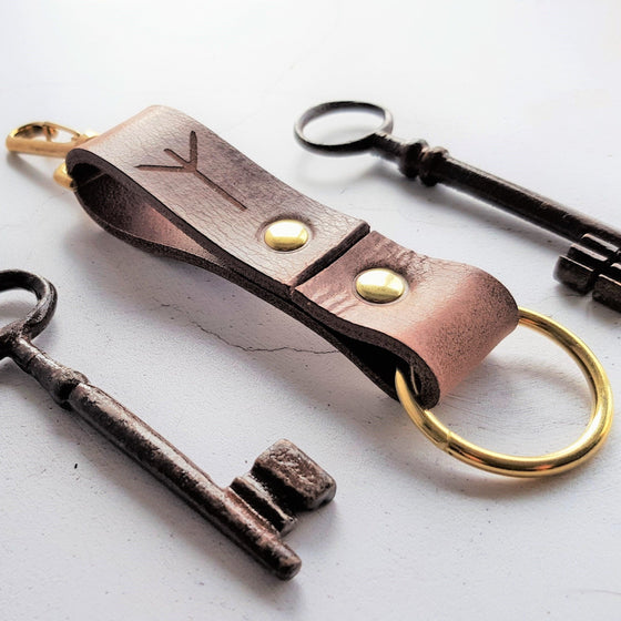 The runic leather key fob with brass hardware material, a custom leather keyring from HÔRD.