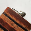 This vintage whiskey flask has been handcrafted using leather remnants.