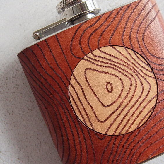 Closer look at the engraving of the mountain hip flask.