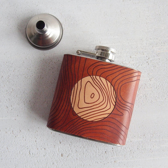 This mountain hip flask has been handcrafted using high quality leather and clad onto a stainless steel flask.