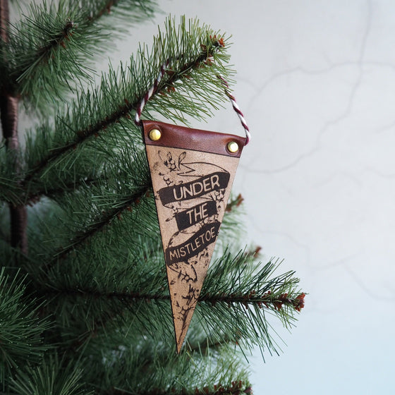 From our range of leather Christmas decorations, this is engraved with the text 'Under the Mistletoe', a perfect addition to your Christmas tree.