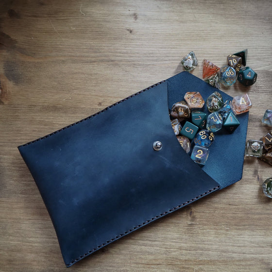 The DnD Dice Pouch from HÔRD that has been hand dyed in blue leather colour and hand stitched in doubled waxed black stitch.