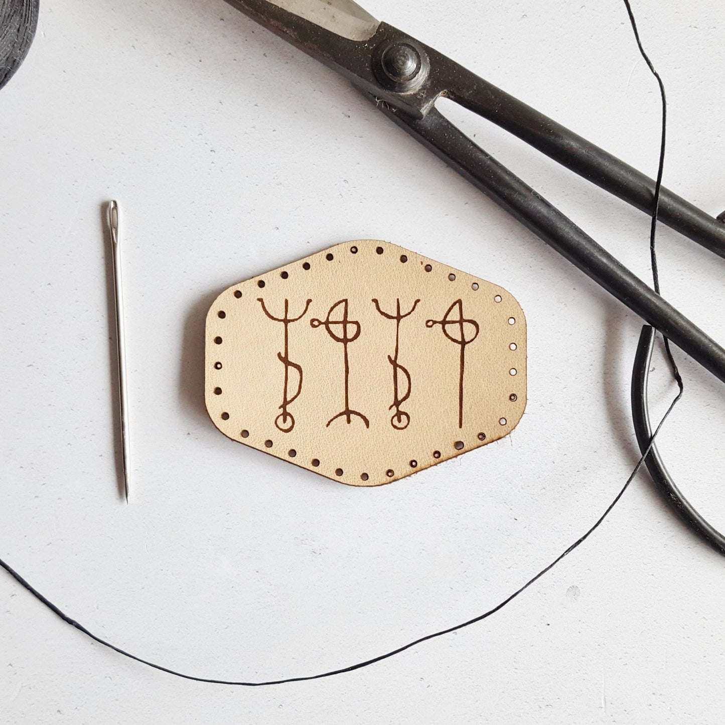 This natural leather patch with pre-cut stitch holes is engraved with draumstafir, an ancient icelandic rune which helps the wearer to dream of their desires. A Runic Patch from Hord.