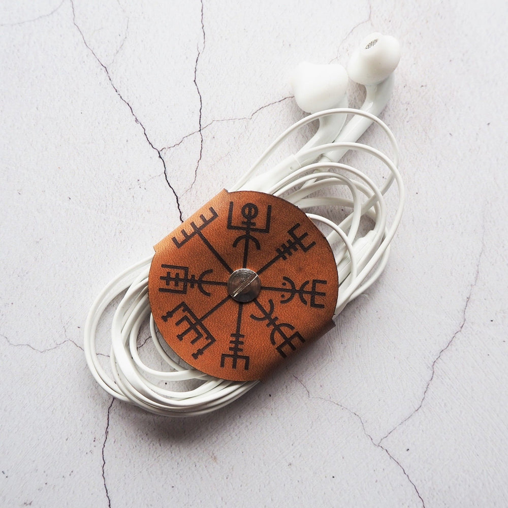 An earphone tidy with Vegivisr symbol engraved, by HÔRD.