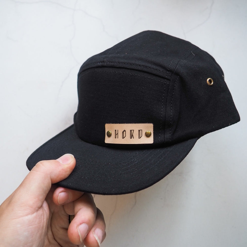 
                  
                    Five Panel Cap with Leather Tab, a camper cap from Hord.
                  
                