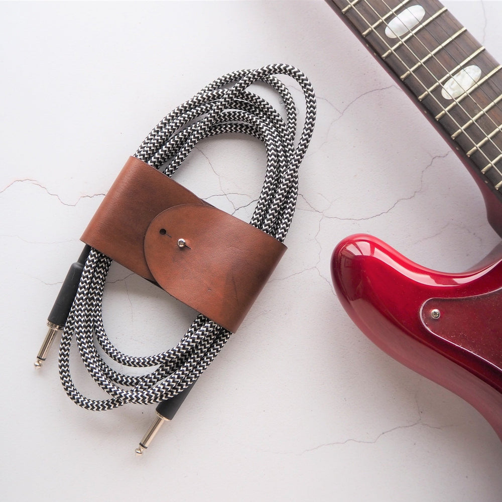 
                  
                    Guitar Cable Tidy - A leather cable tidy offering from HÔRD.
                  
                