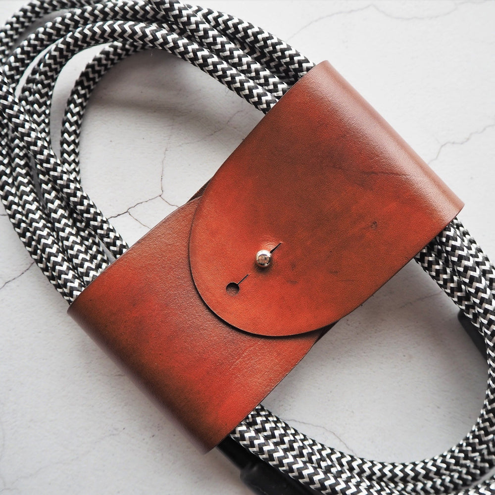 
                  
                    A guitar cable neatly wrapped with using HÔRD's guitar cable tidy.  
                  
                