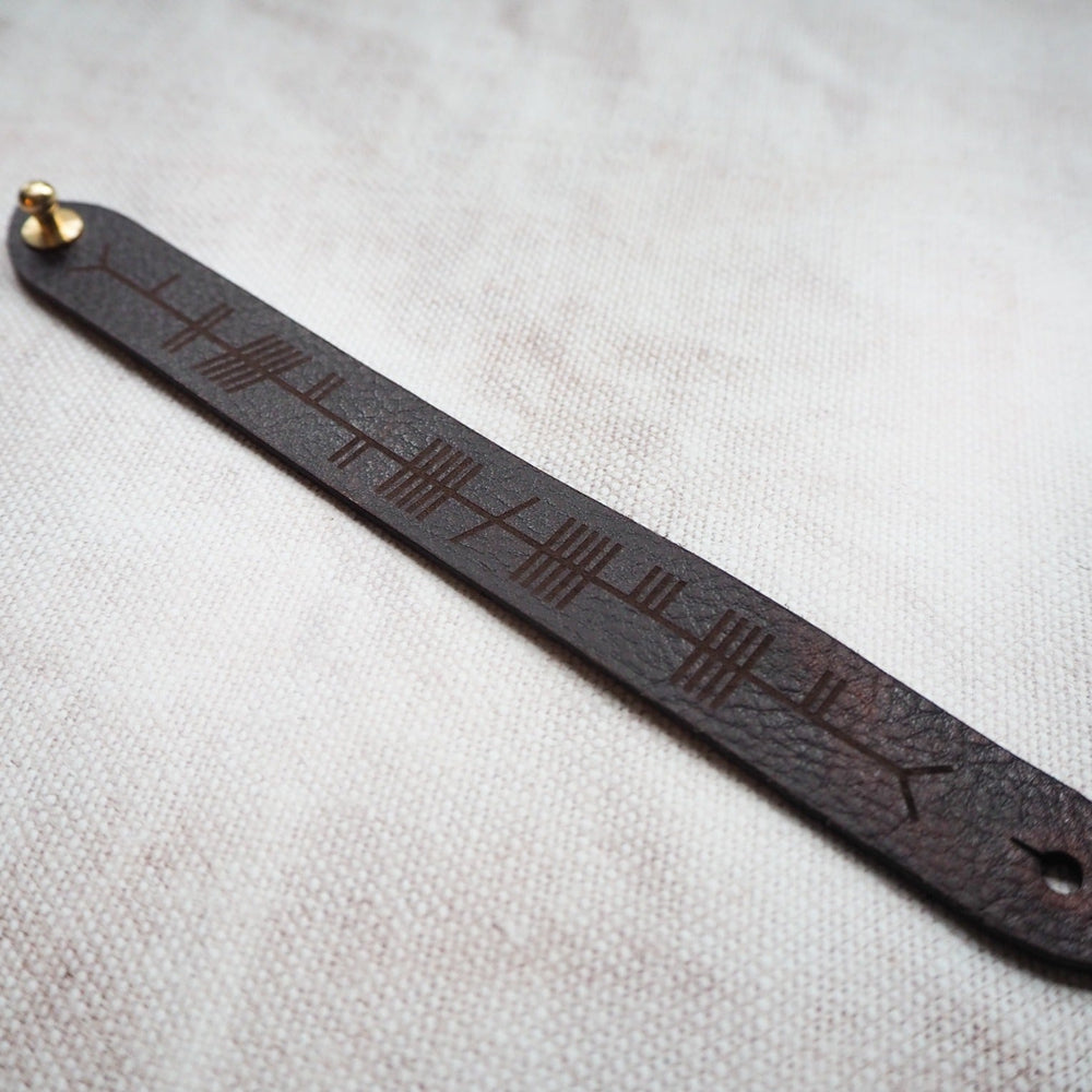 
                  
                    Full view of the Ogham Leather Cuff by HÔRD.
                  
                