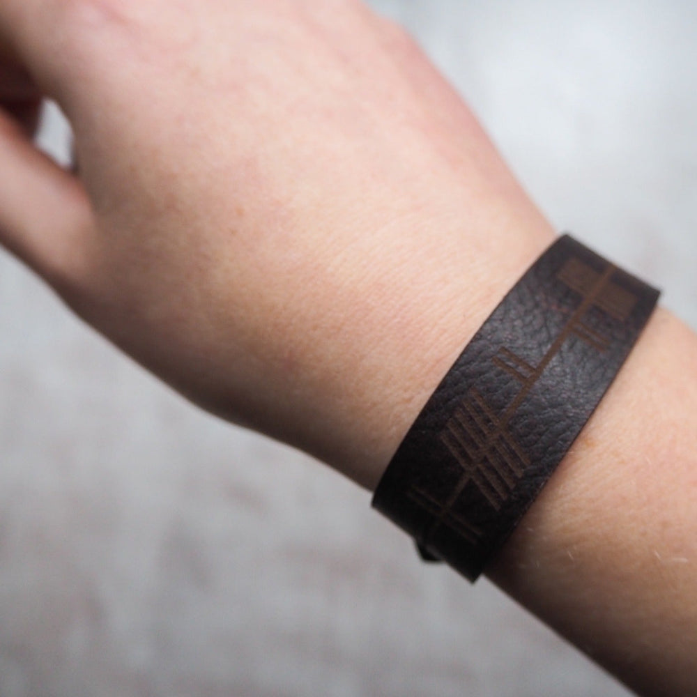 
                  
                    Leather Cuff by HÔRD featuring the Ogham Leather Cuff in plum brown leather colour.
                  
                