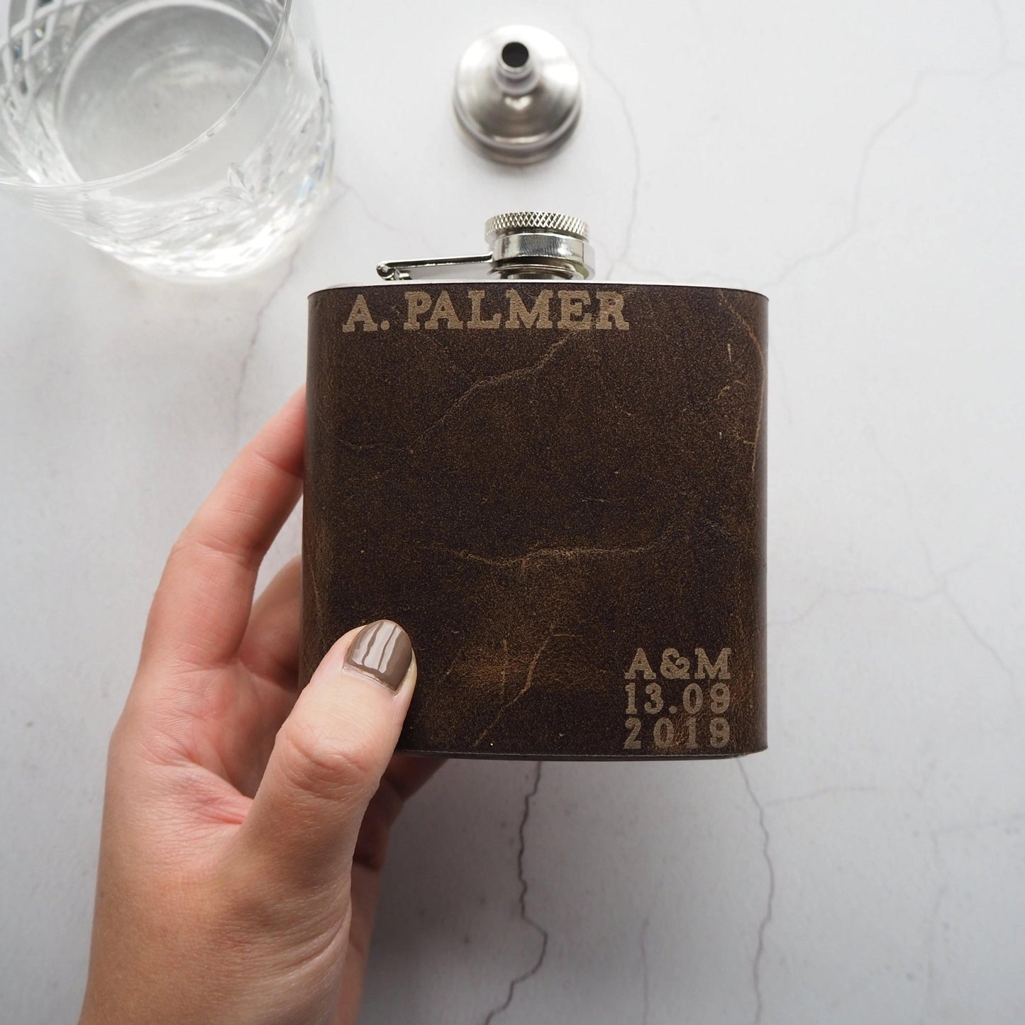 Personalised Wedding Hip Flask that has been engraved with a custom name, custom initials, and date.