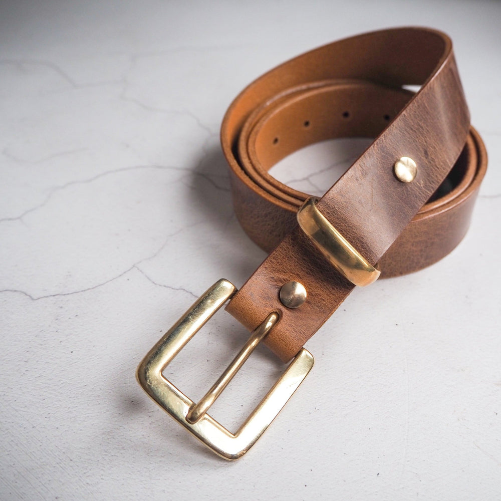 The tan leather belt has been handcrafted using full grain leather.
