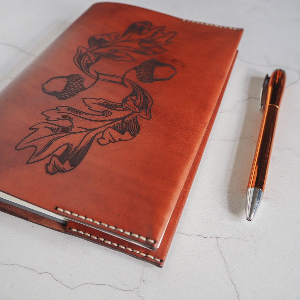 
                  
                    The Acorn notebook by HÔRD featuring oaknut and leaf engraving.
                  
                