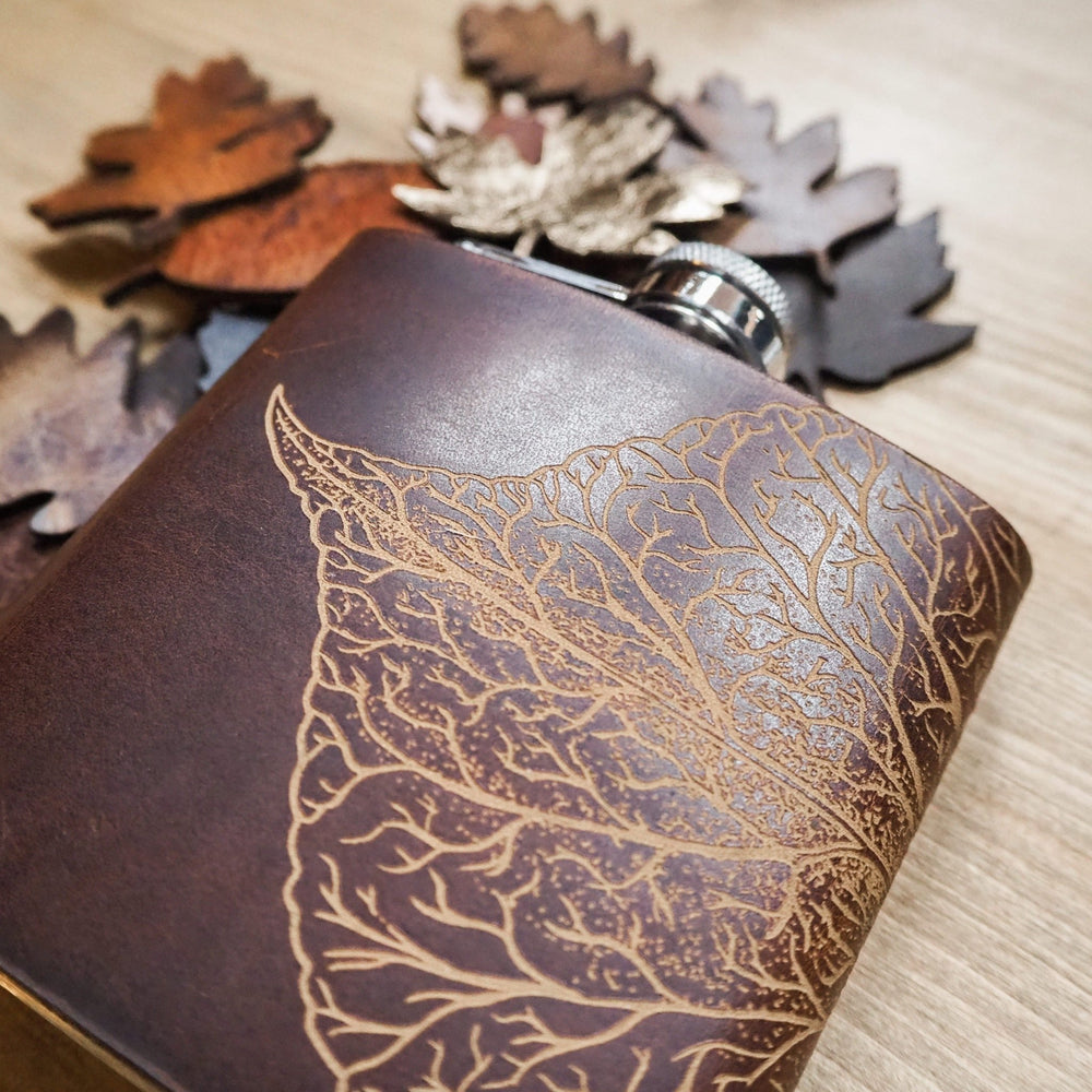 
                  
                    This custom engraved flask is engraved with a mulberry leaf design on brown leather colour.
                  
                