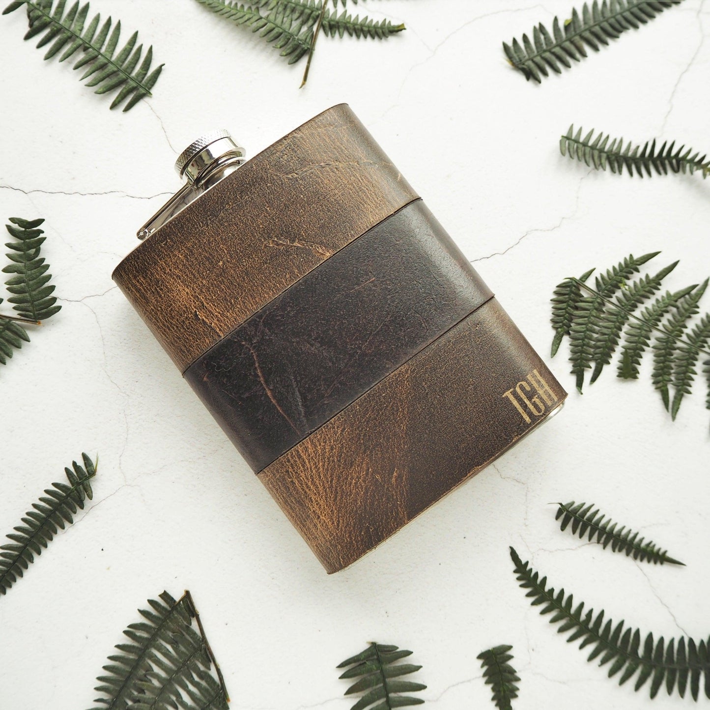 The Oak and Peat Leather Flask, an engraved leather hip flask from Hord.