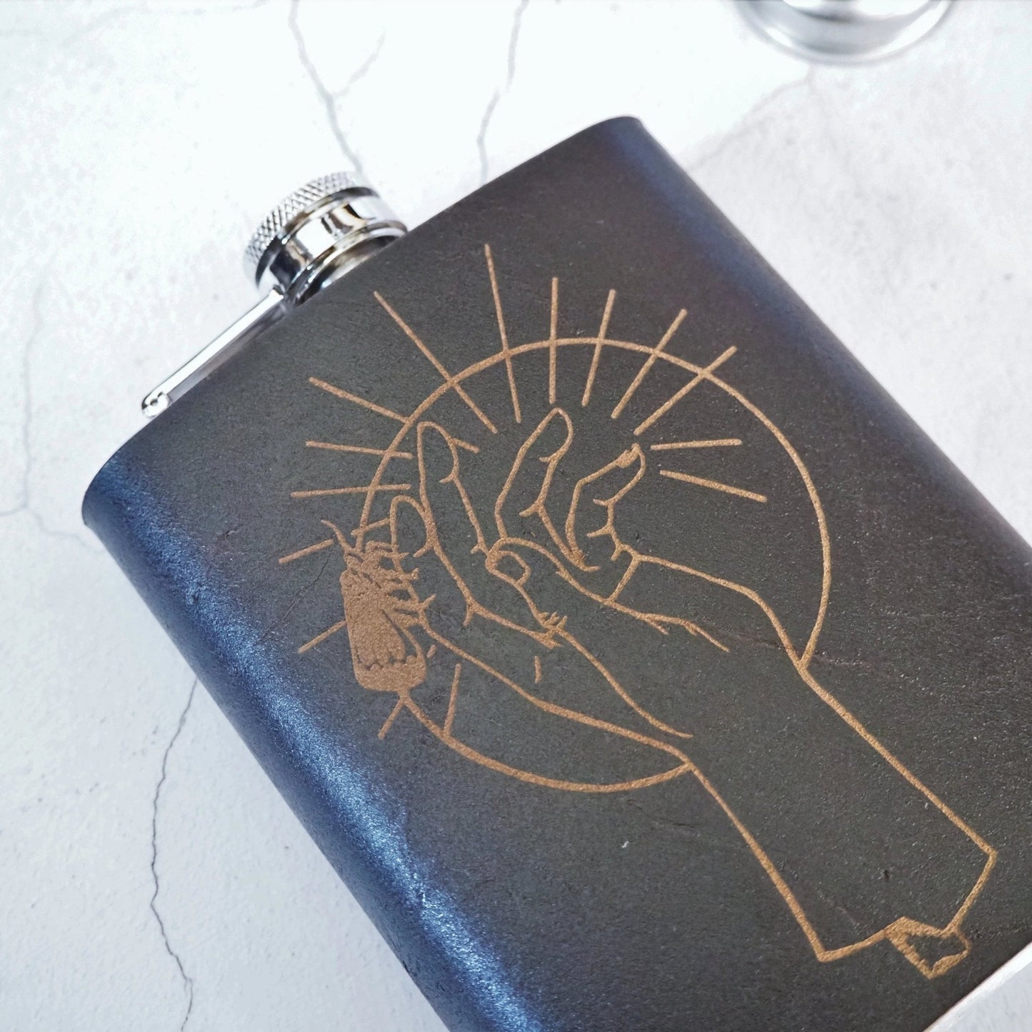 This personalized flask from Hord has a moth on a hand engraved.