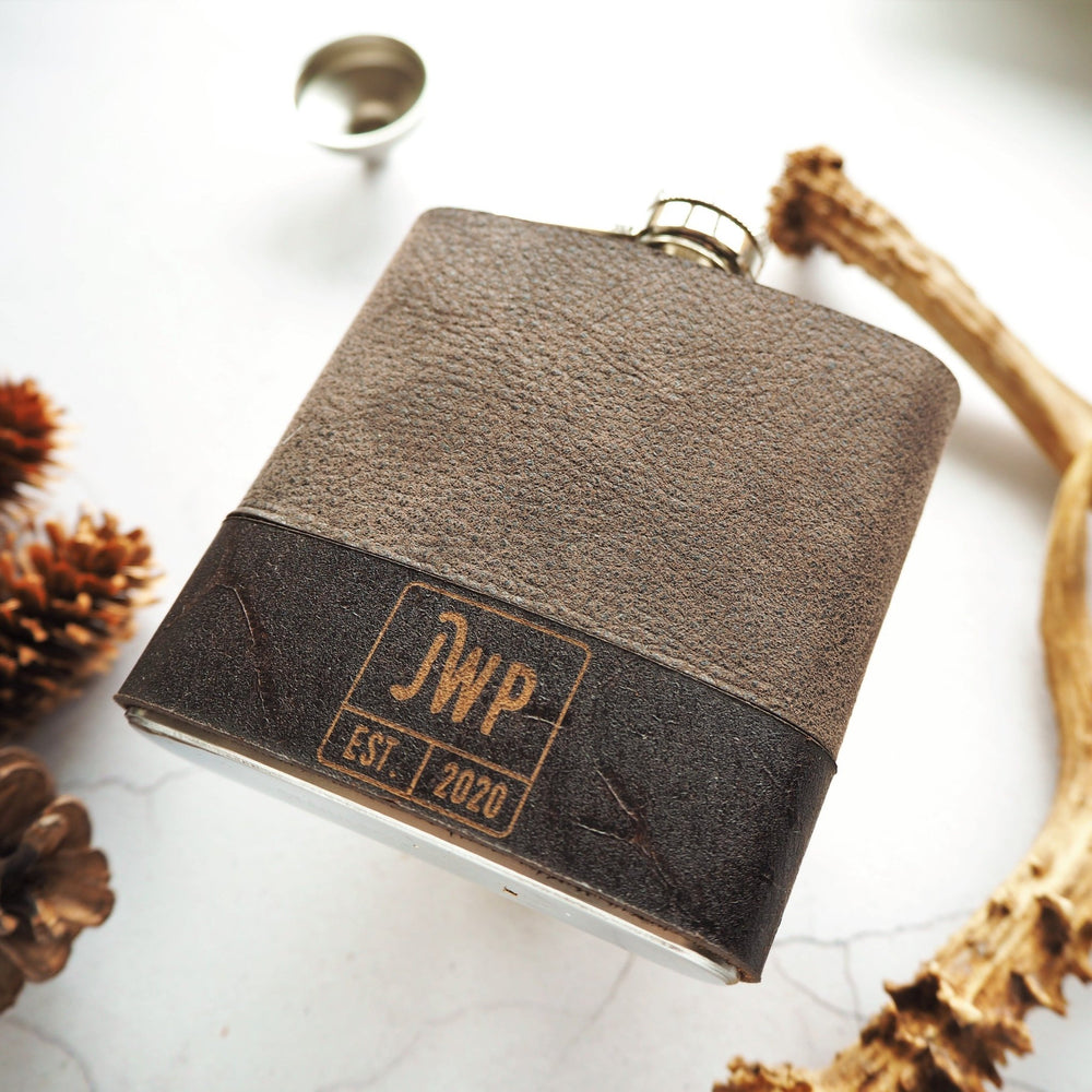 
                  
                    This monogram hip flask has been personalised with an initial and custom text and date in the bottom of the hip flask in a square box.
                  
                
