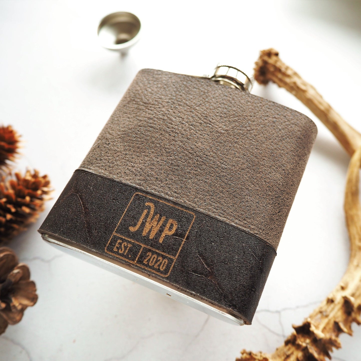 This monogram hip flask has been personalised with an initial and custom text and date in the bottom of the hip flask in a square box.