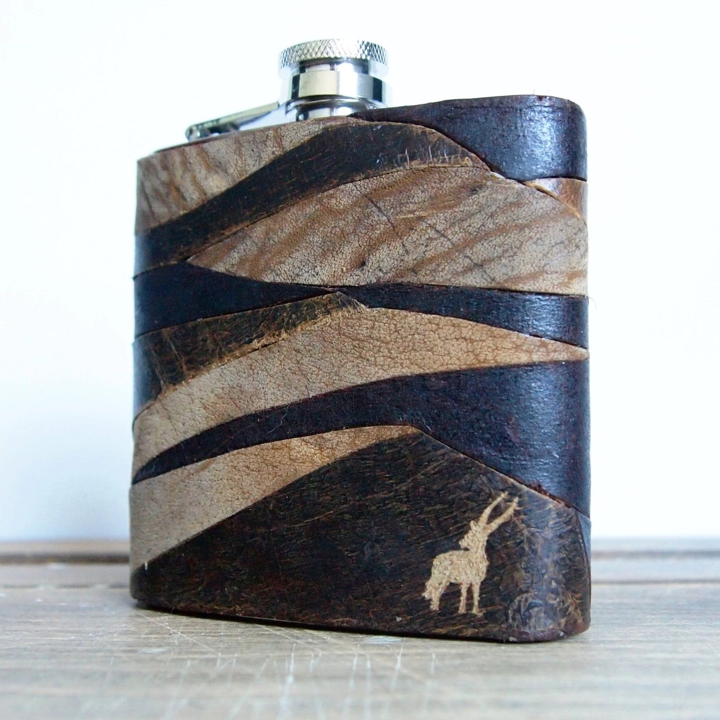 The Survivor Leather Flask, a leather whiskey flask.